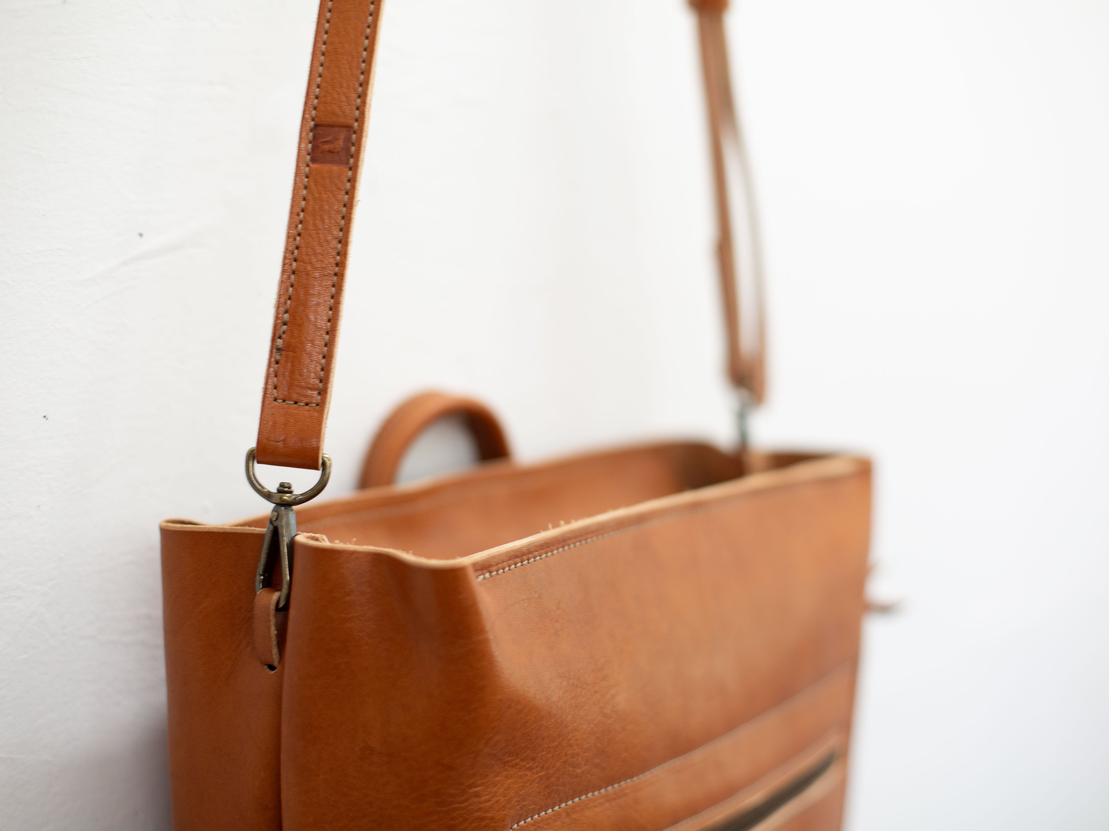 Removing the backpack straps and attaching the lobster clamps of the crossbody strap to the side loops of the bag turns the backpack into a messenger bag. 
