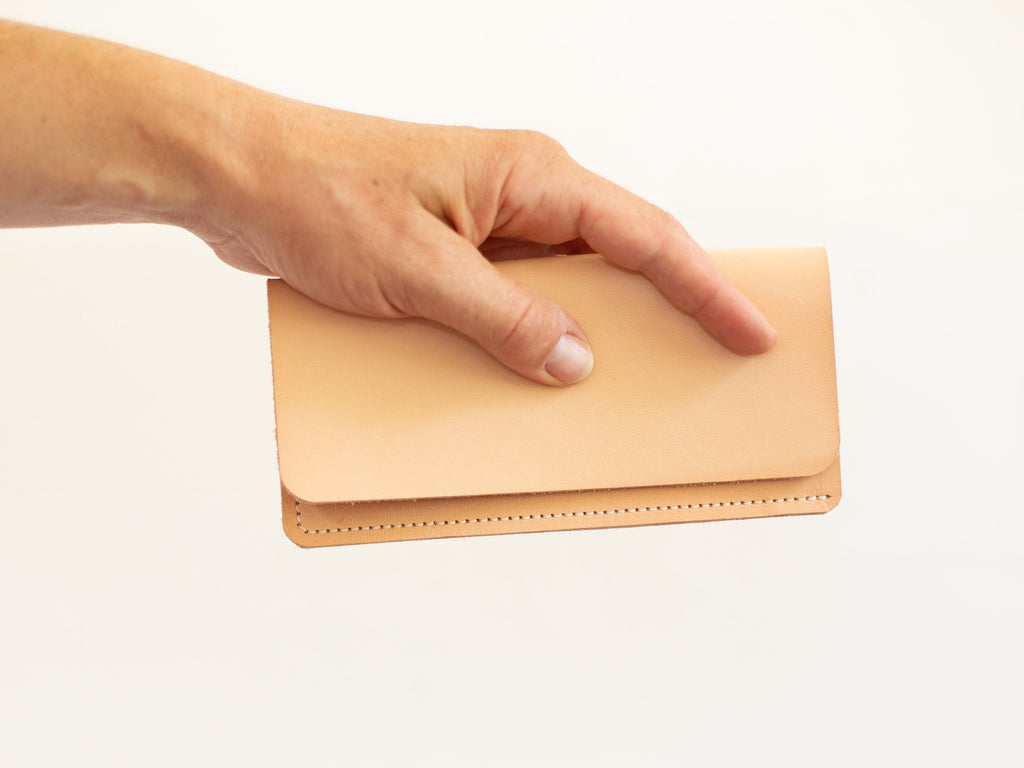 The leather wallet is closed on this picture that shows its simplistic and minimalistic design. 