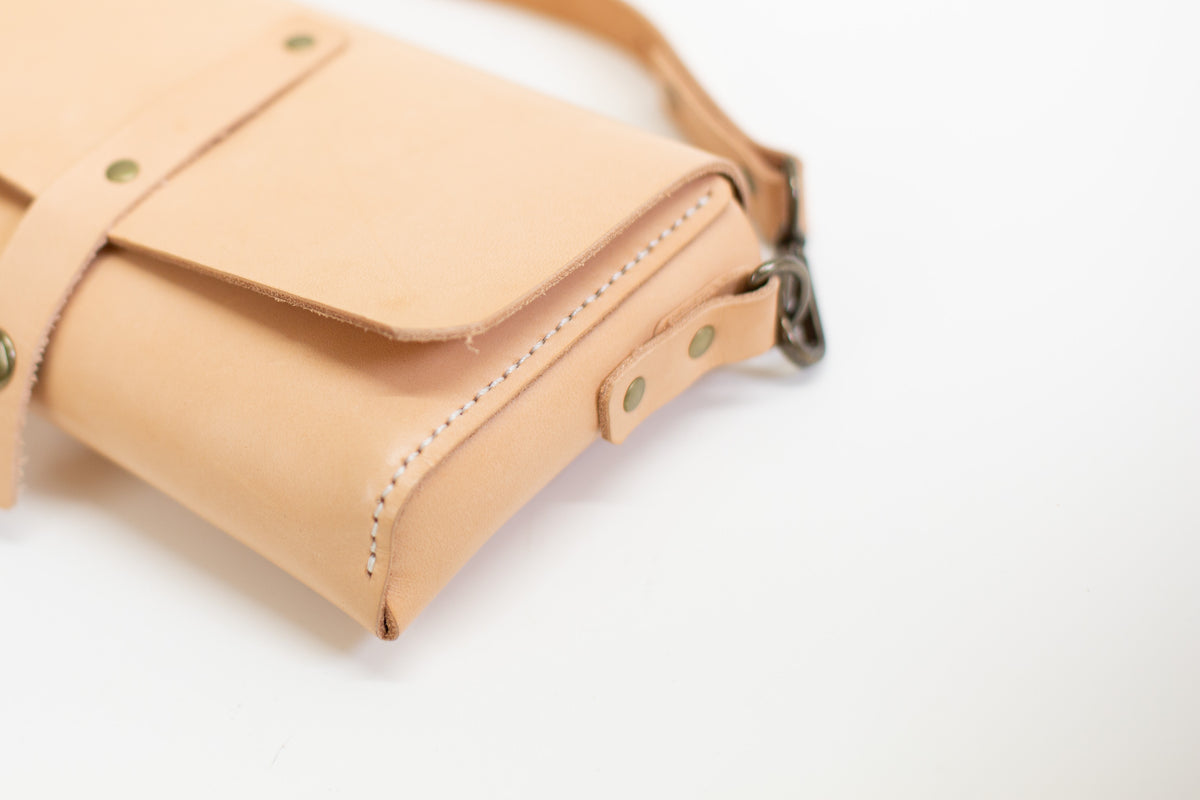 The seam is sewn by hand and everything else it attached with rivets so that the small convertible fanny pack is very durable. 