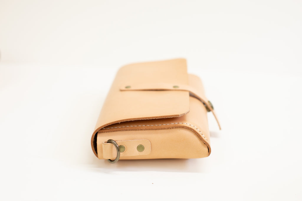 The belt bag is seen from the side, with the hand stitched seam well visible. 