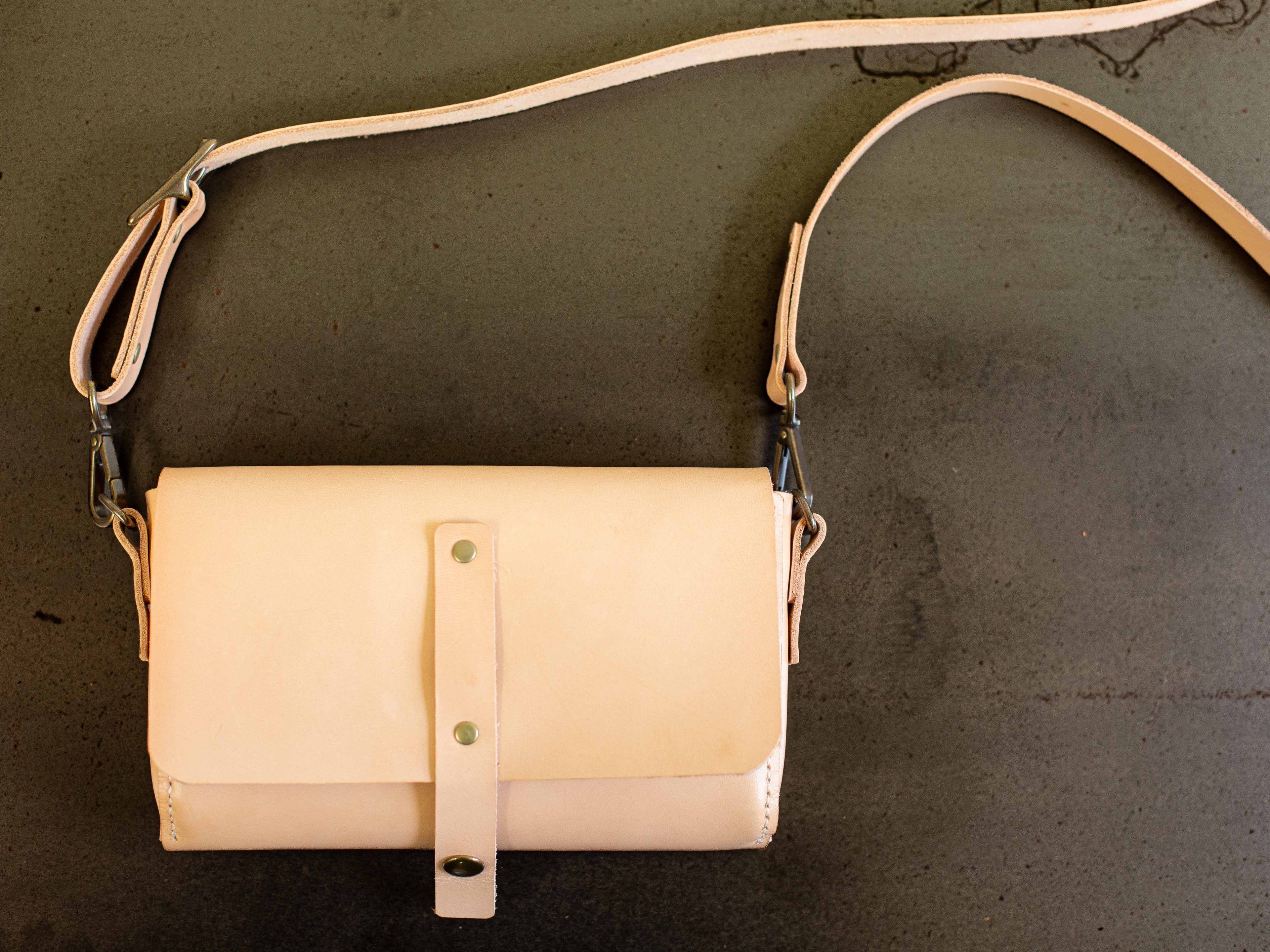 The light tan leather fanny pack can be converted to a crossbody purse. 