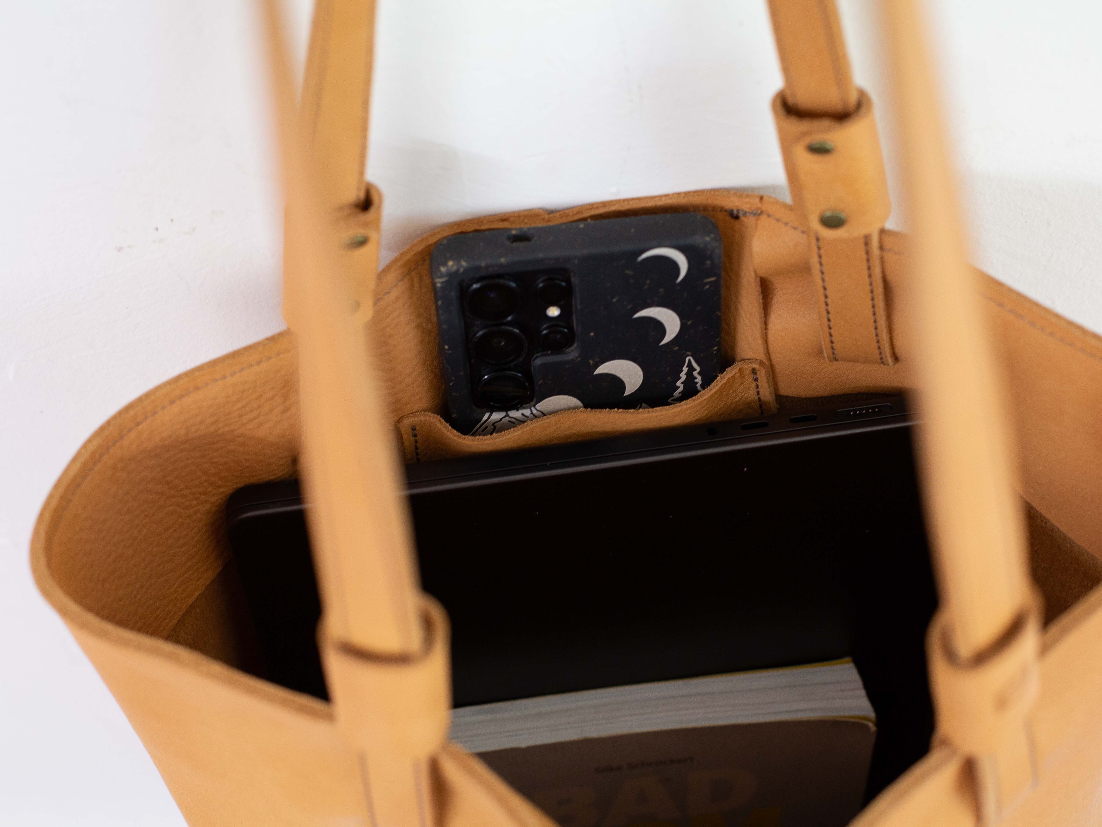 Look inside the large compartment and phone pocket on the inside of the leather shoulder bag. 