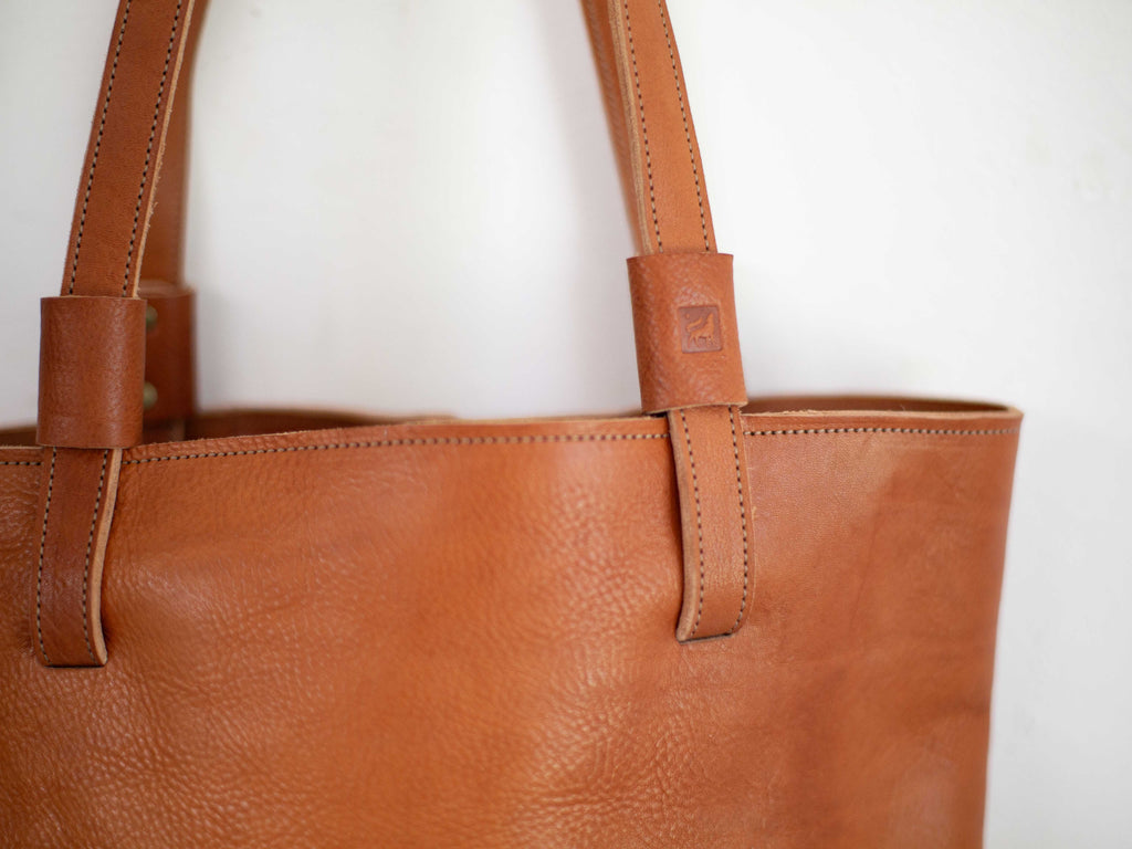 The leather shoulder straps can be removed when the crossbody strap is attached. 