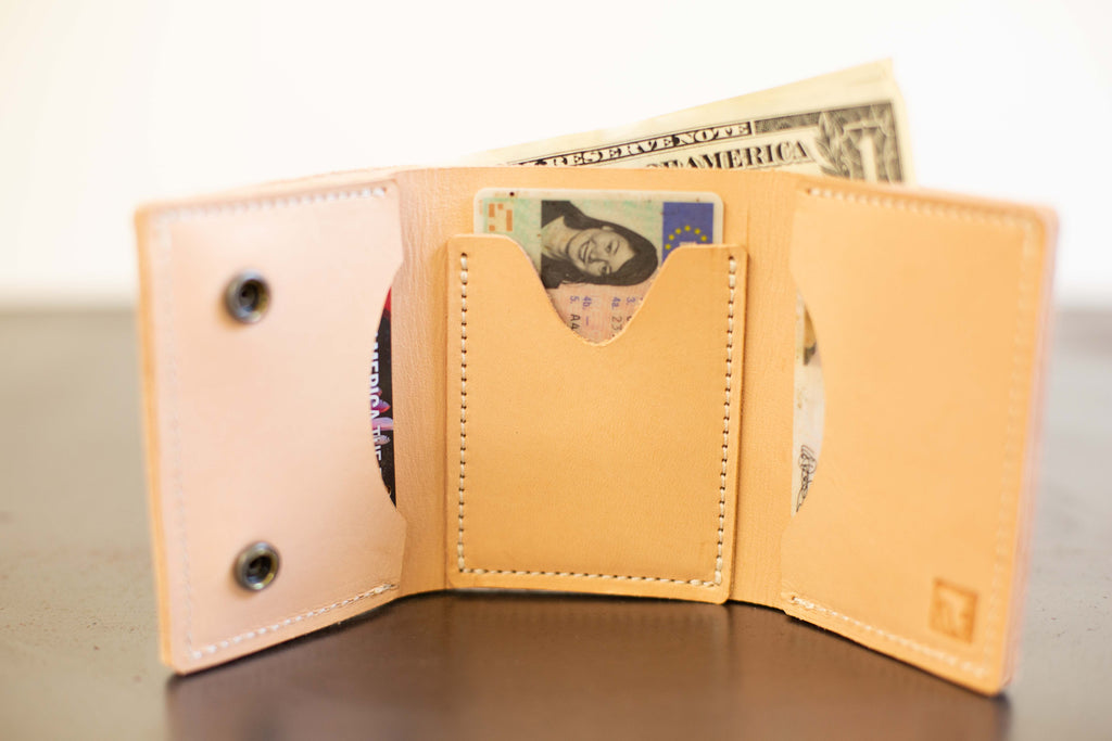 The inside of the opened leather wallet is pictured. The card slots and cash compartment are visible. 