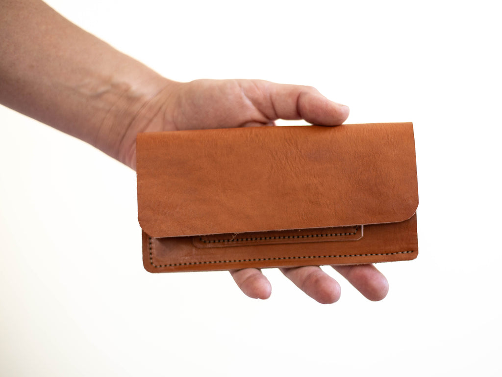 The wallet has one card pocket and is made with red brown sustainable organic leather, from hides from cattle raised in organic or regenerative farming. 
