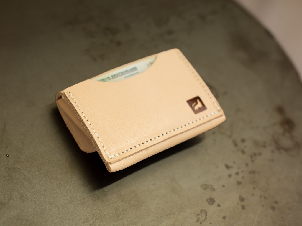 On the back of the organic leather coin wallet is a card pocket with the branded logo of White Wolf Leather Studio. 
