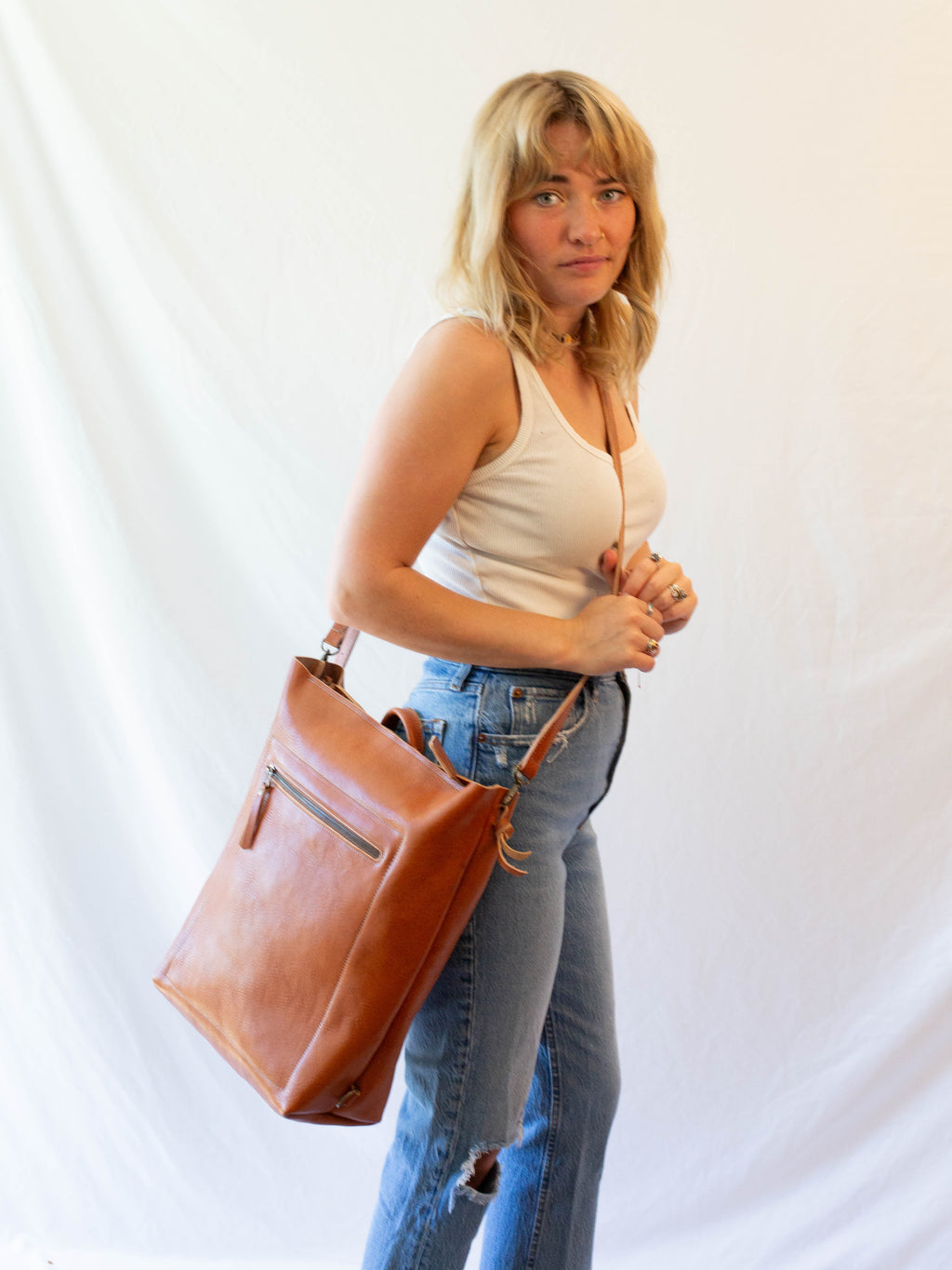 The leather bag can be worn as large crossbody bag or as backpack. 