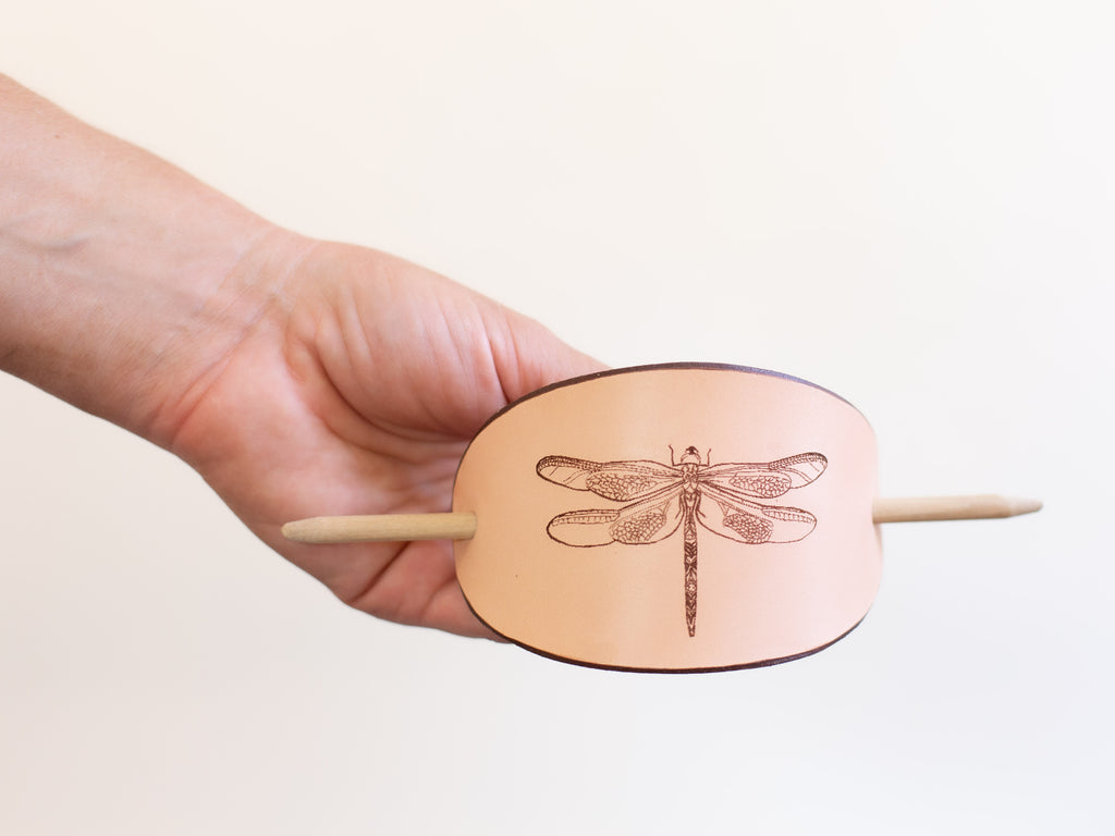 The large leather hair slide with wooden stick is made with organic leather that is sustainably sourced and non-toxic.