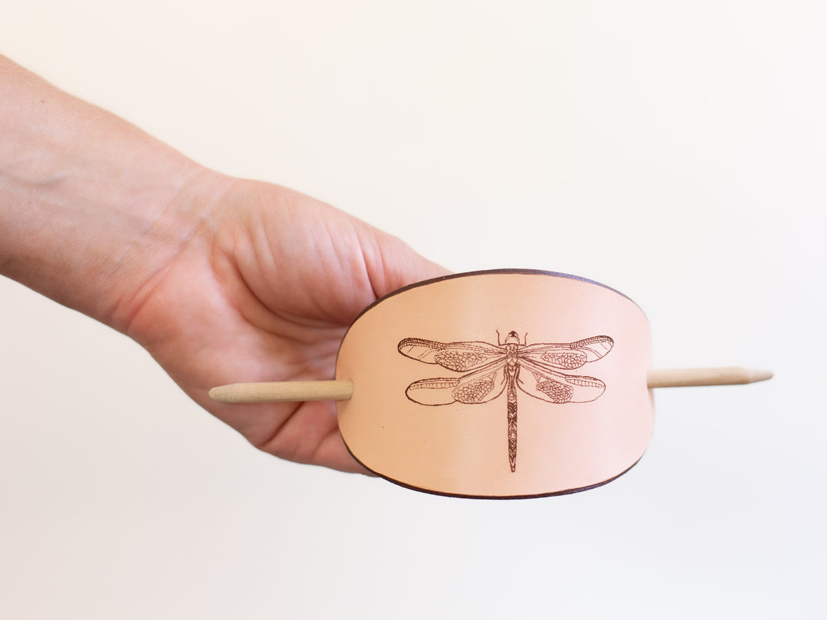 The large leather hair slide with wooden stick is made with organic leather that is sustainably sourced and non-toxic.