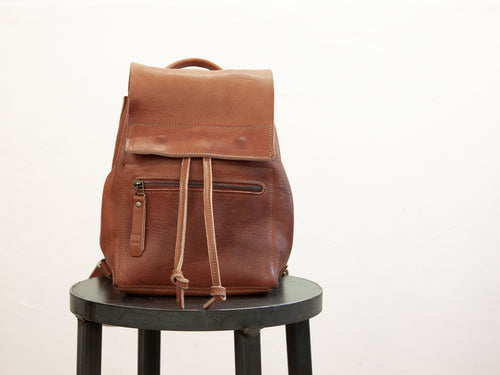 Small drawstring backpack, made with ethically sourced sustainable leather, is seen from the front.