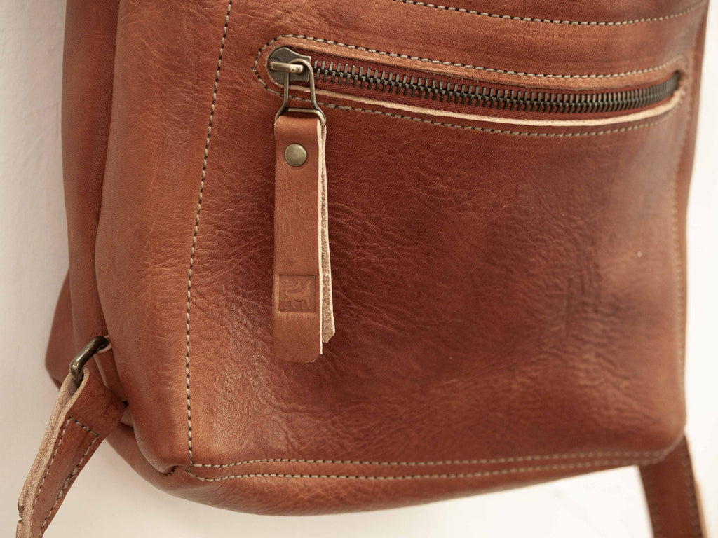 The front pocket closes with a Swiss quality riri zipper and has the White Wolf Leather Studio logo stamped on it. 