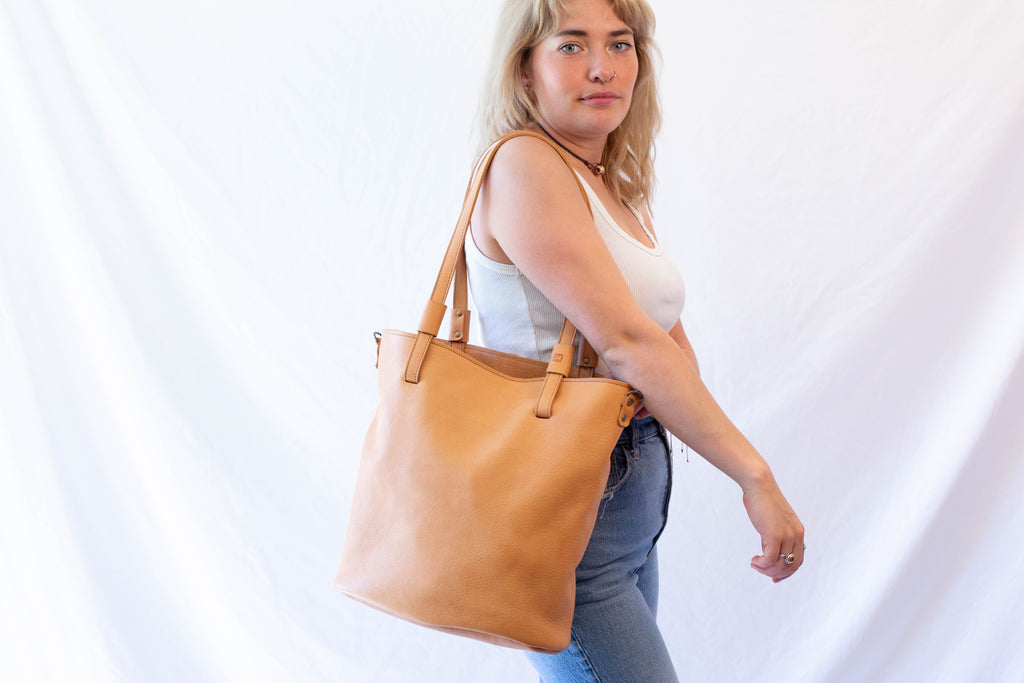 Tan colored leather shoulder bag from sustainably sourced leather from organic farming. 