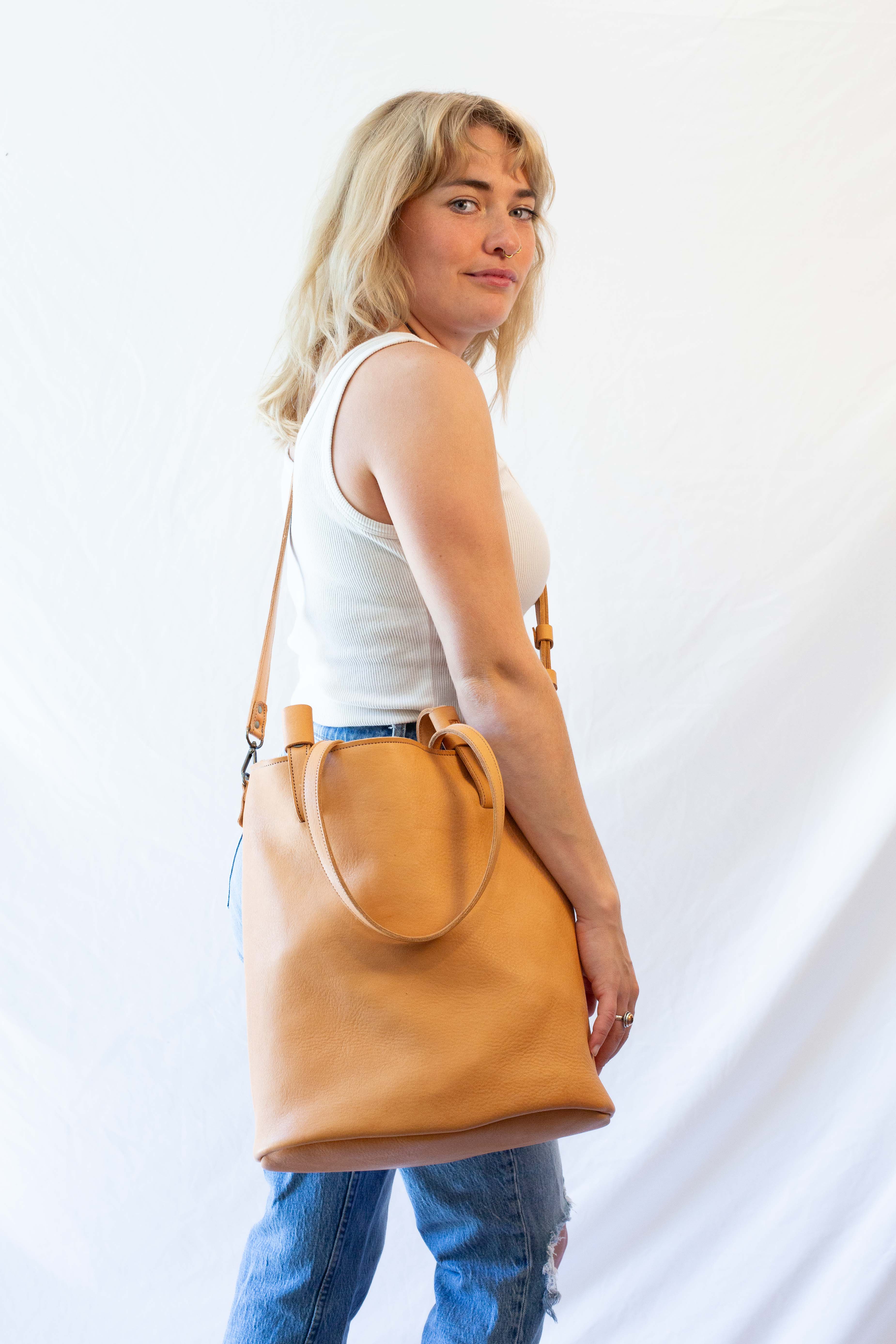 Convertible crossbody bag from tan colored soft leather, convertible to shoulder bag.