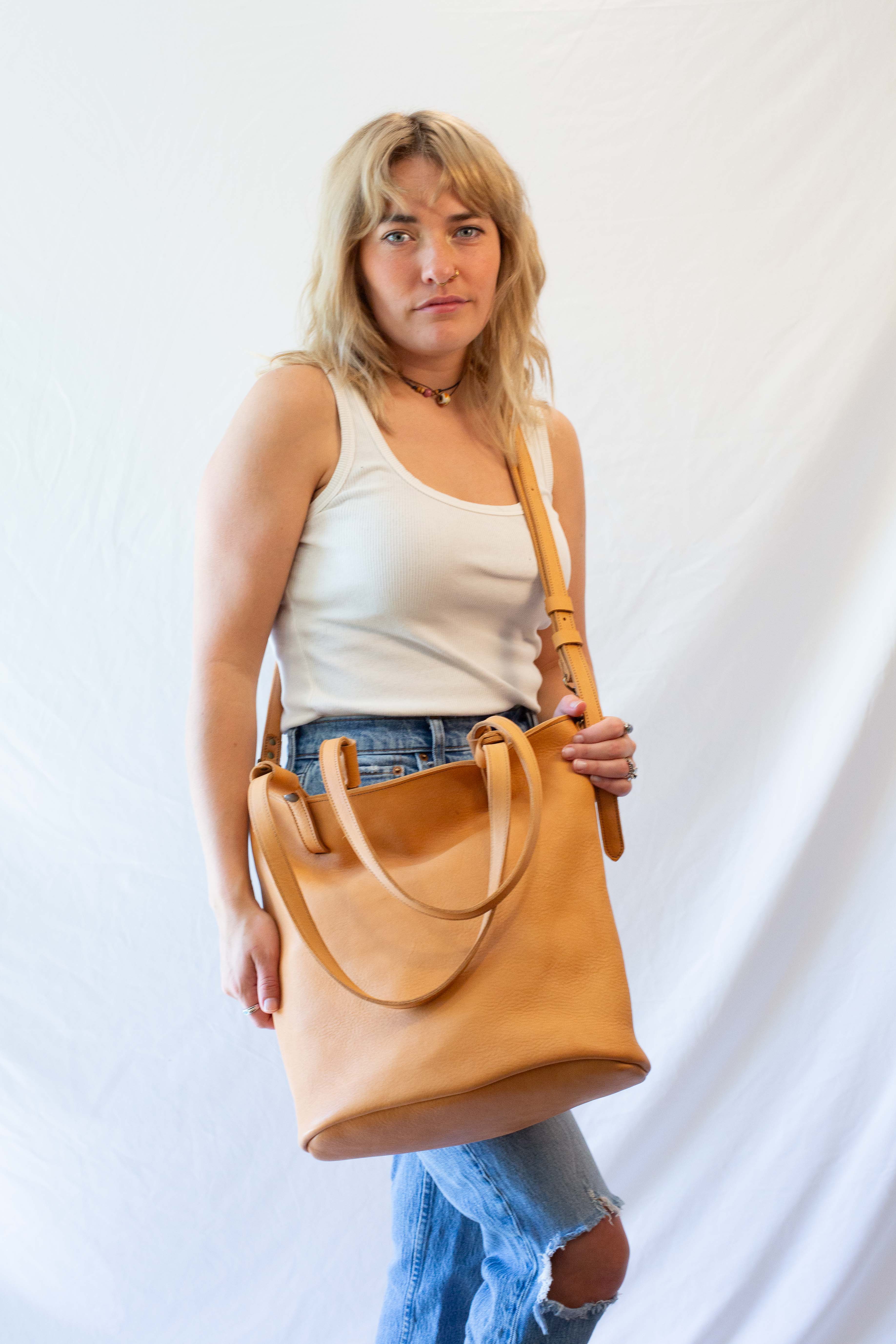 Large leather shoulder bag from sustainable leather, converted to a crossbody bag. 