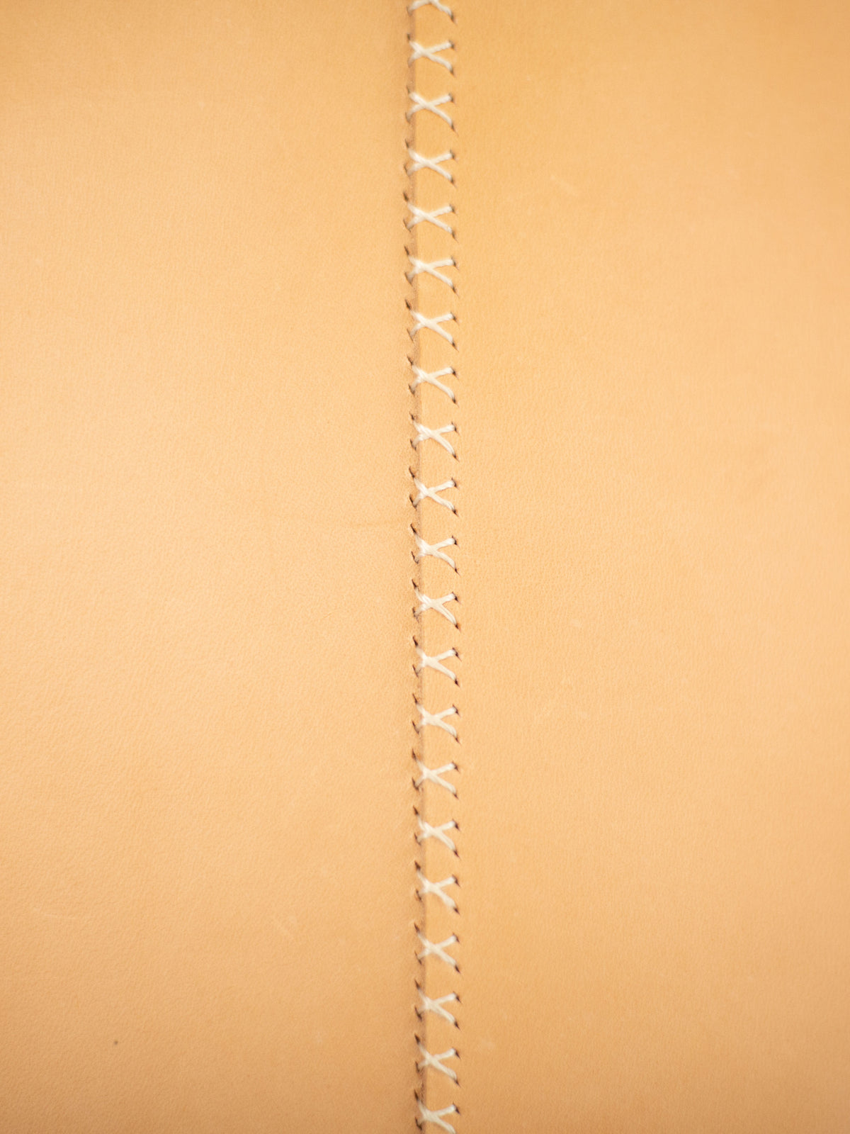The seam on the back of the leather market bag is stitched by hand. 