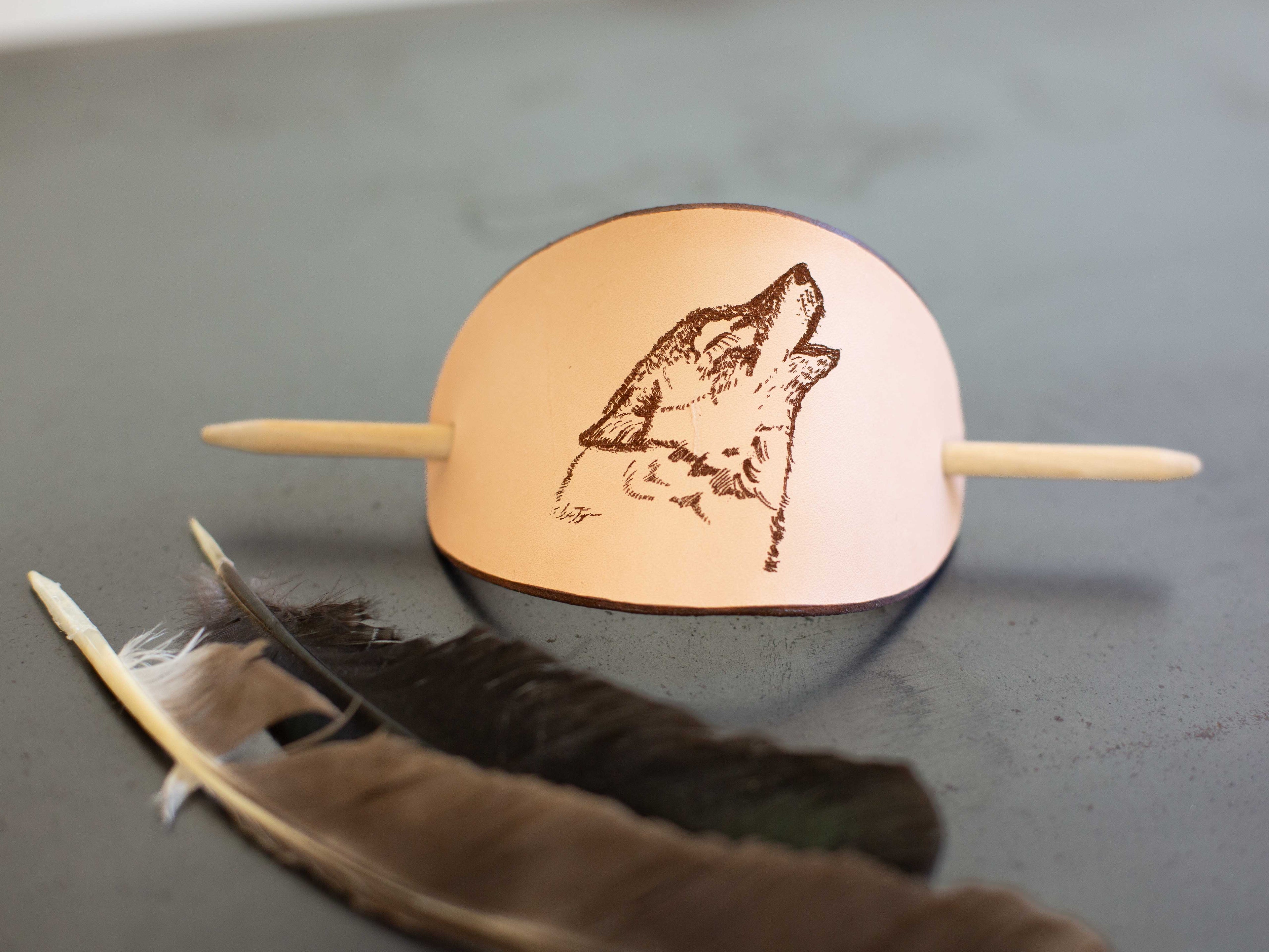 The barrette with nature inspired wolf laser engraving is made with sustainable organic veg tan leather. 