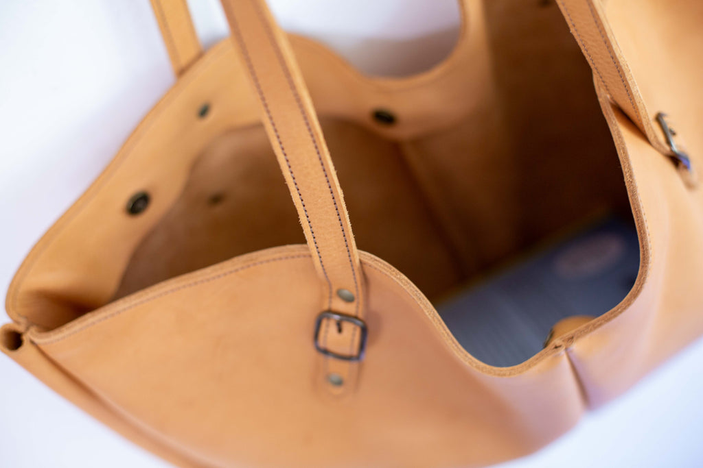 Close-up of the large tan shoulder bag, to show dimensions and how roomy the one compartment is. 