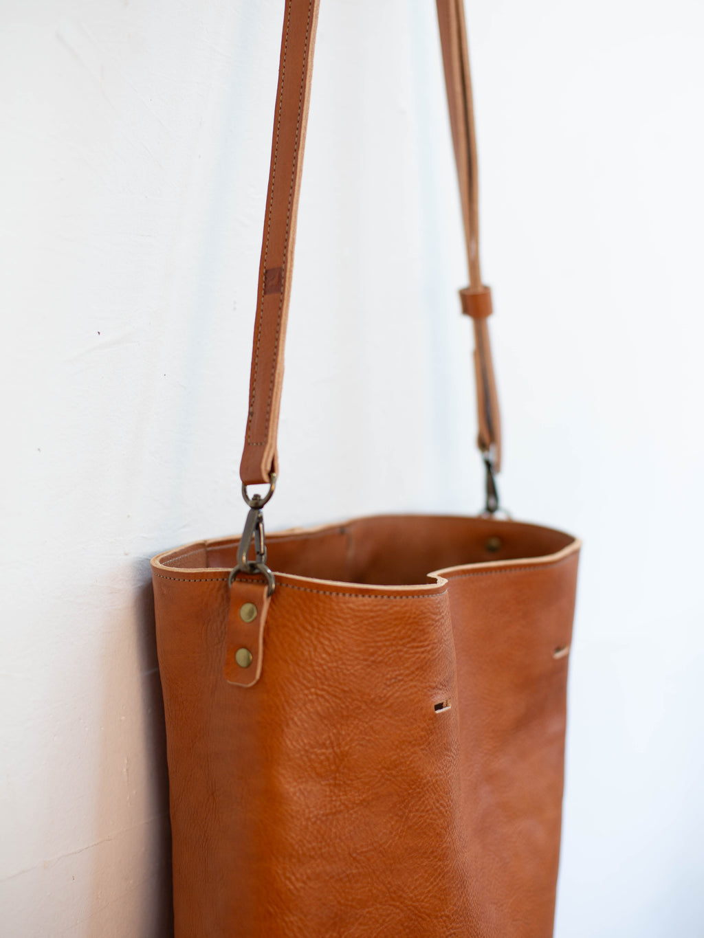 When used with the optional crossbody strap the handles can be removed from the leather shoulder bag to turn it into a messenger bag. 