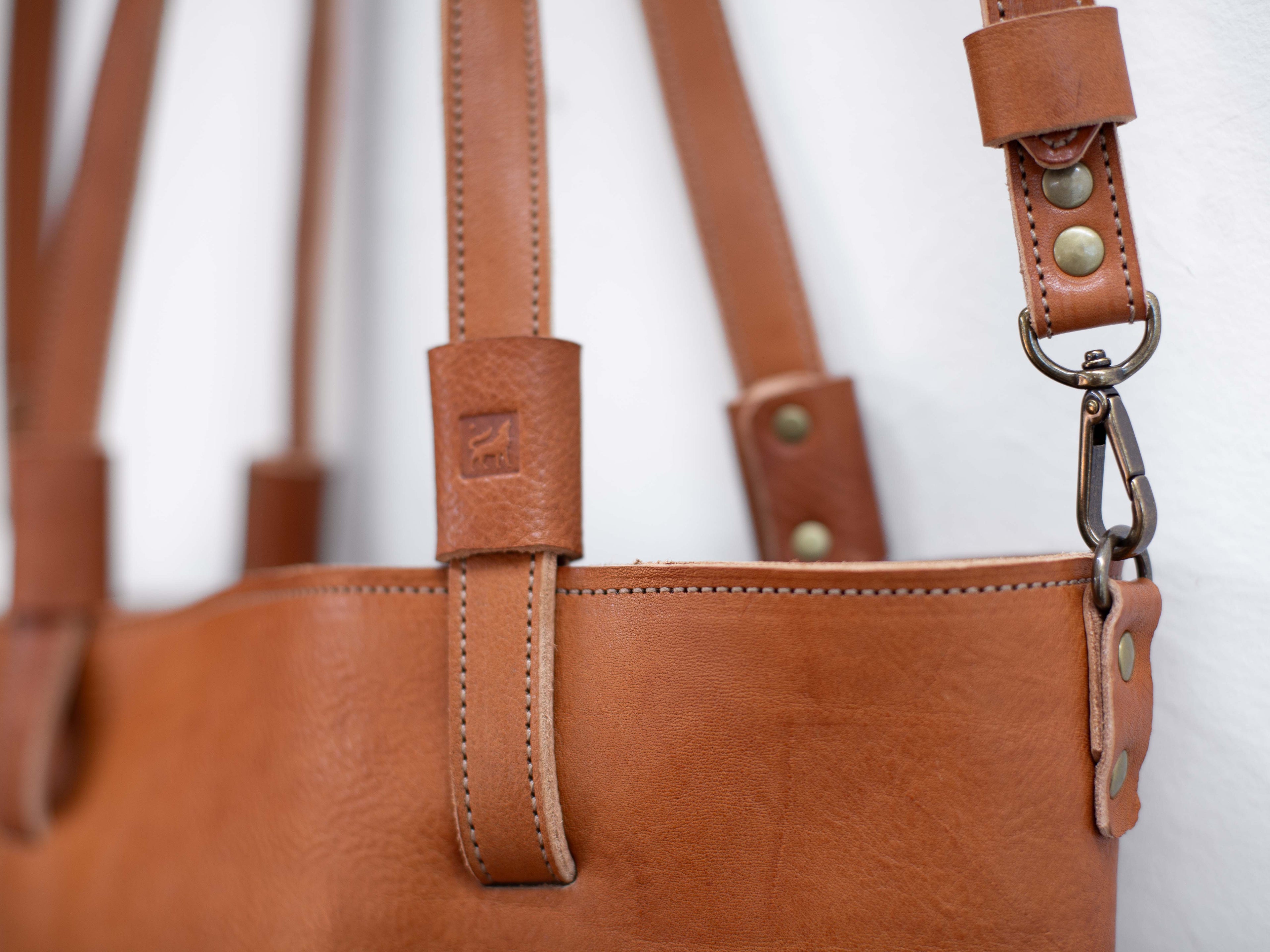 The optional crossbody strap can be attached to the organic non-toxic leather shoulder bag with a lobster clamp that is attached to a metal D-ring. 