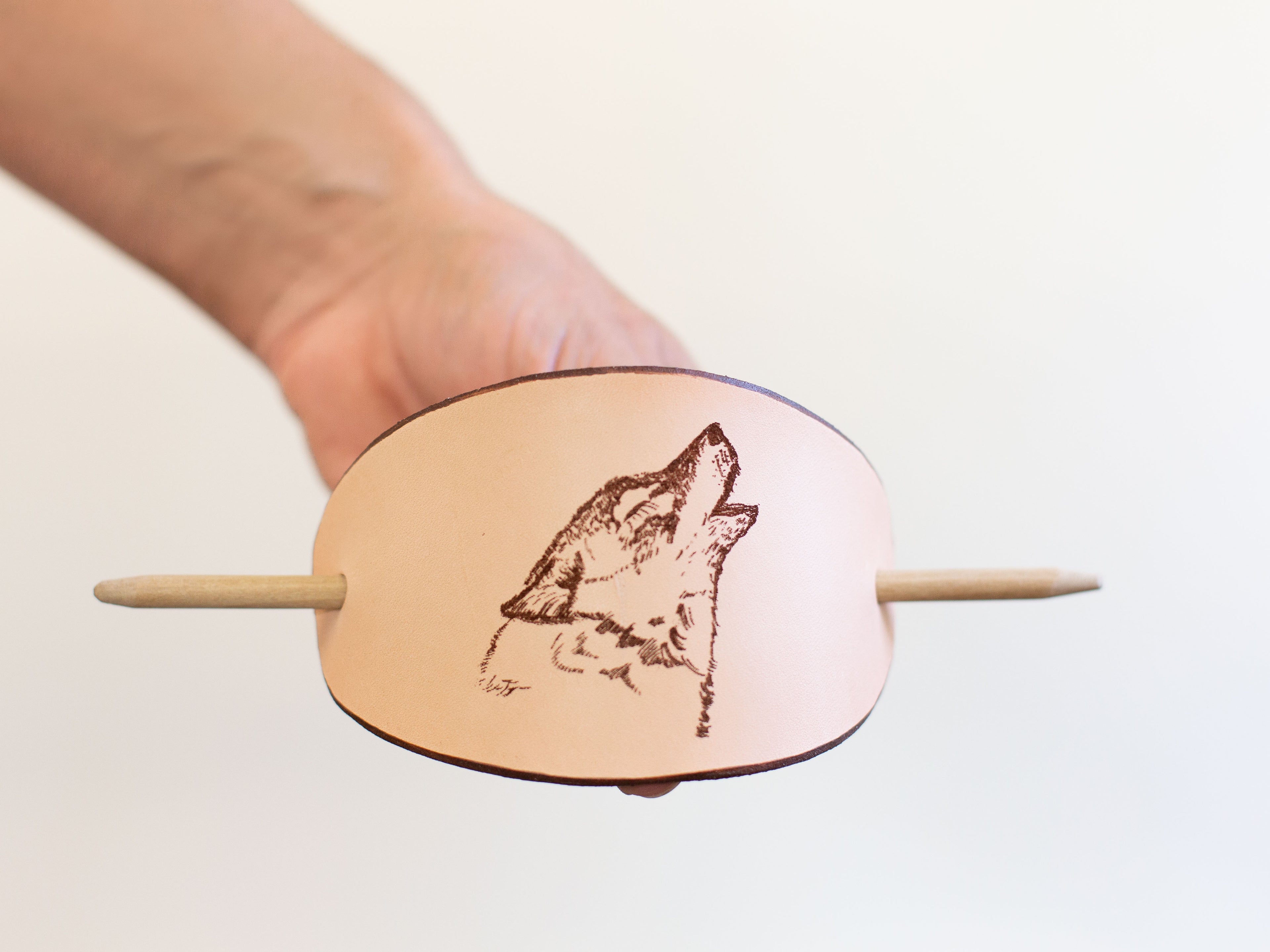 The leather barrette with wolf laser engraving is large and works very well for quick hair-dos with long hair and messy buns. 