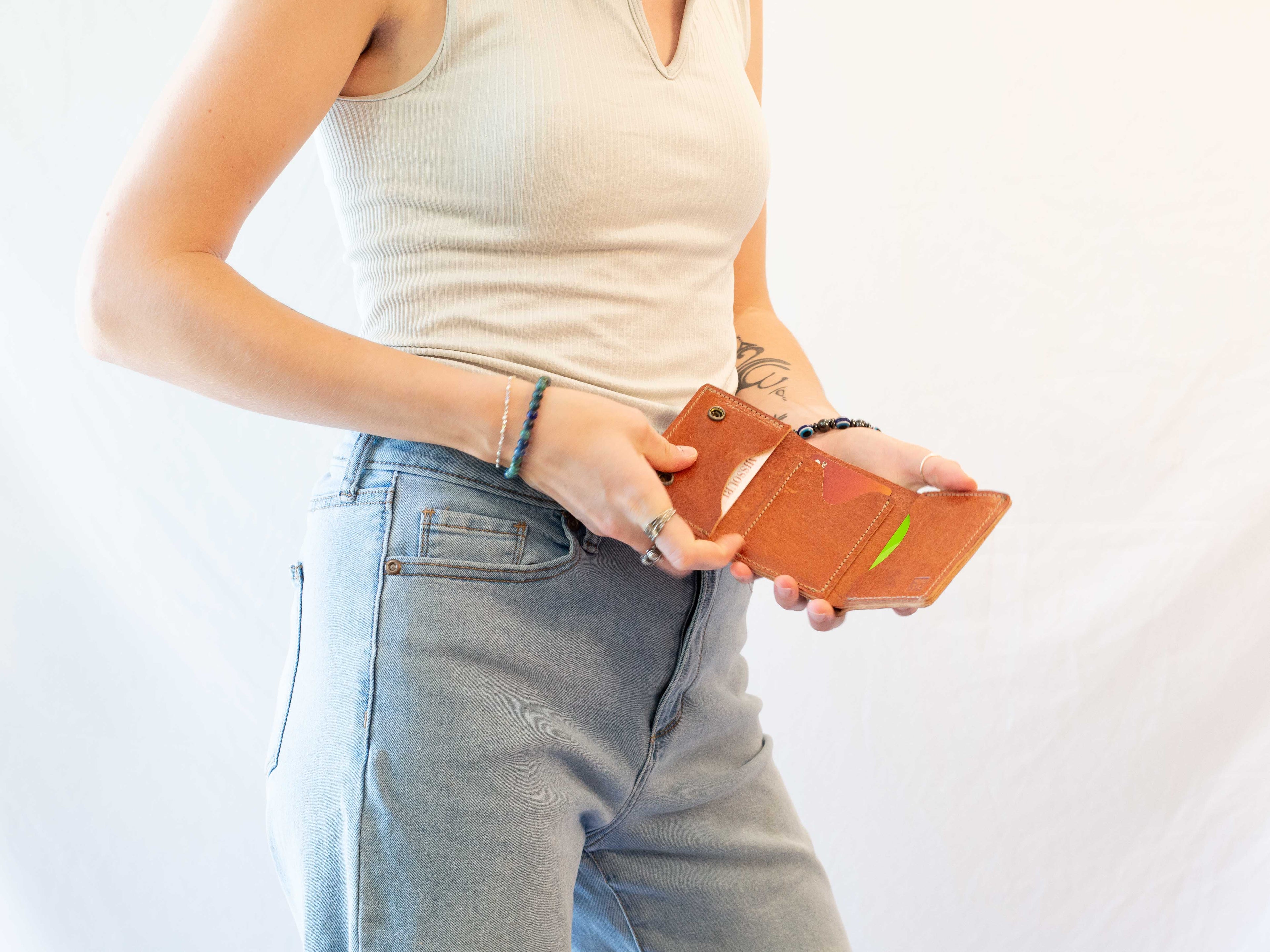 When the leather wallet is open, you can see the three slots for cards, the cash compartment and how it is folded three times. 