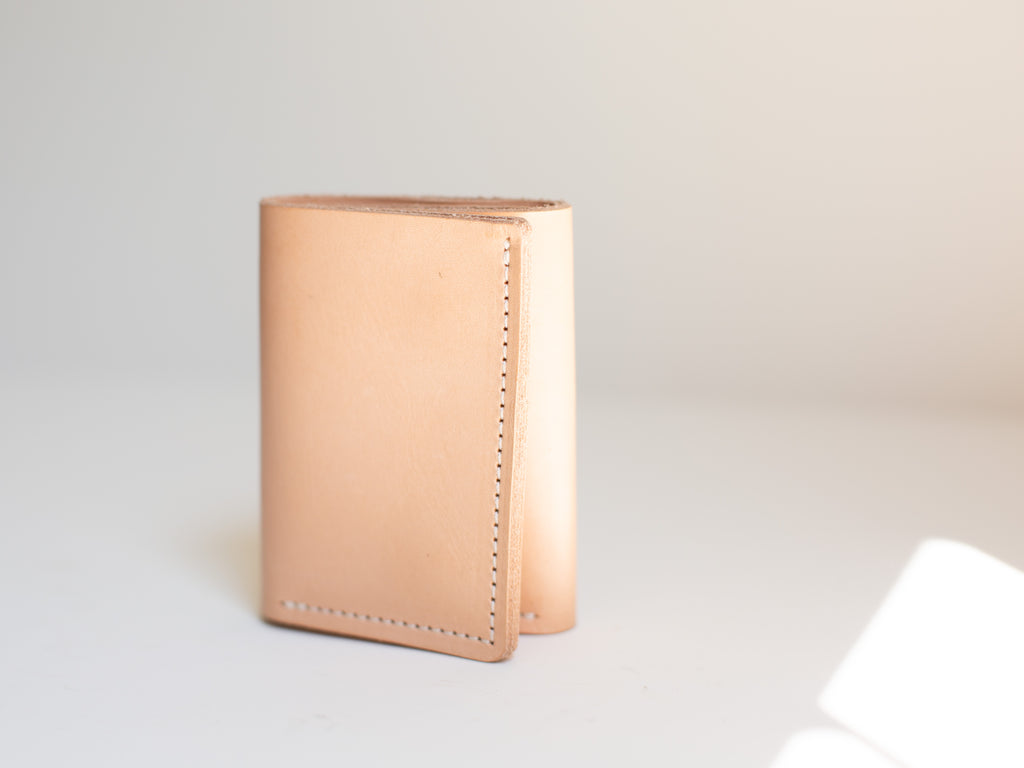 The trifold card and cash wallet is shown closed to show the clean seams and minimalist design. 