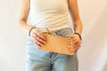 The pencil case from sustainably sourced veg tanned leather is held by a model to show the dimensions in relation to hands etc. 
