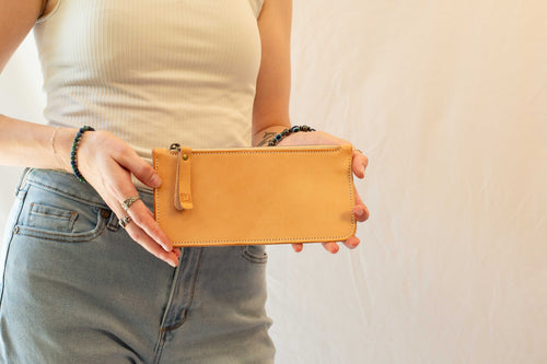 The front side of the artists leather case is held and shown by a person. 