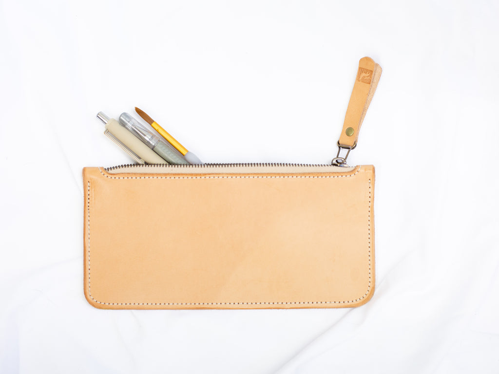 The pencil case is made from sustainably sourced veg tanned leather and closes with a riri zipper with the White Wolf Leather Studio logo. 