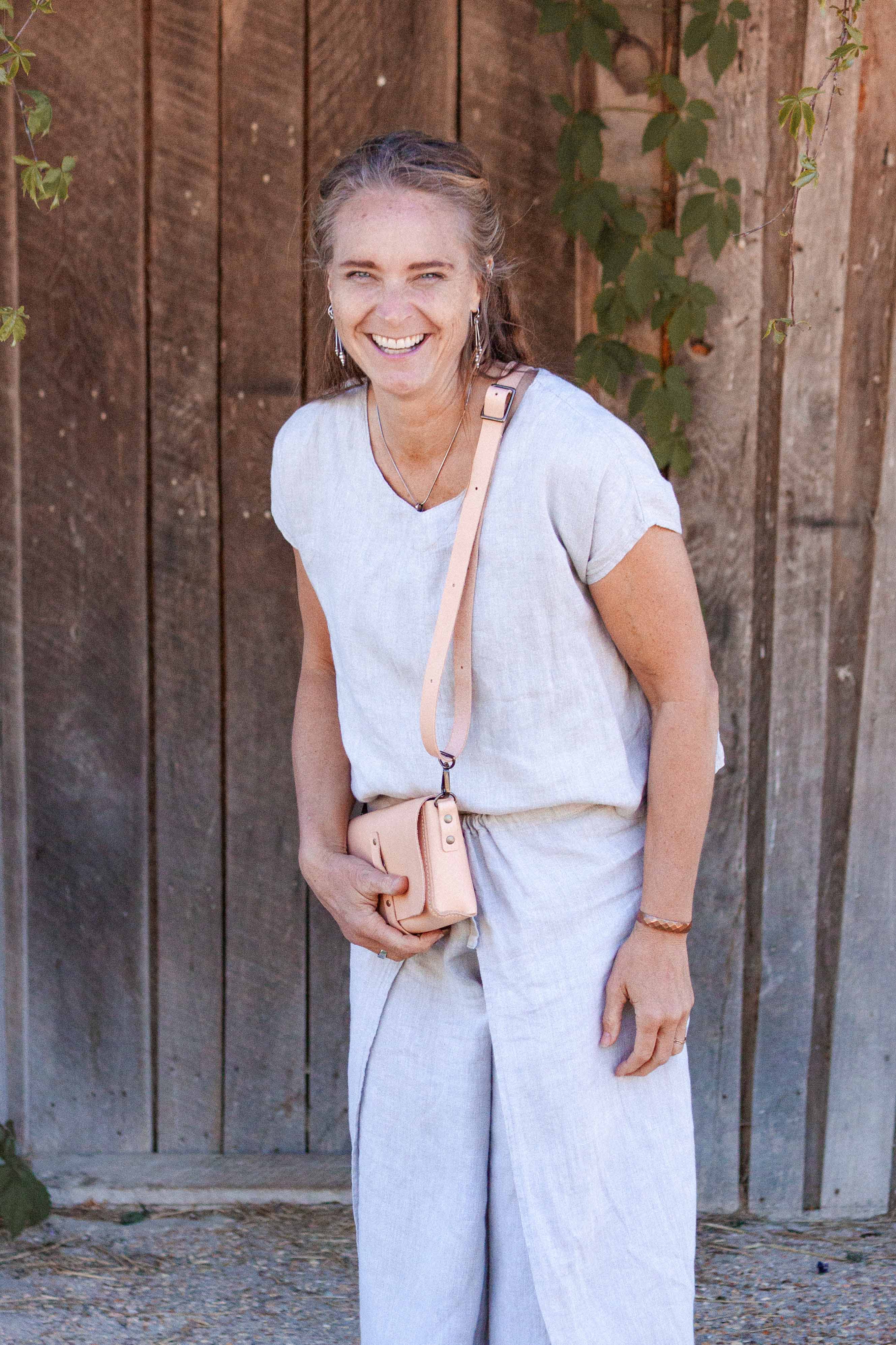 A model showing a way to style the small leather crossbody purse.