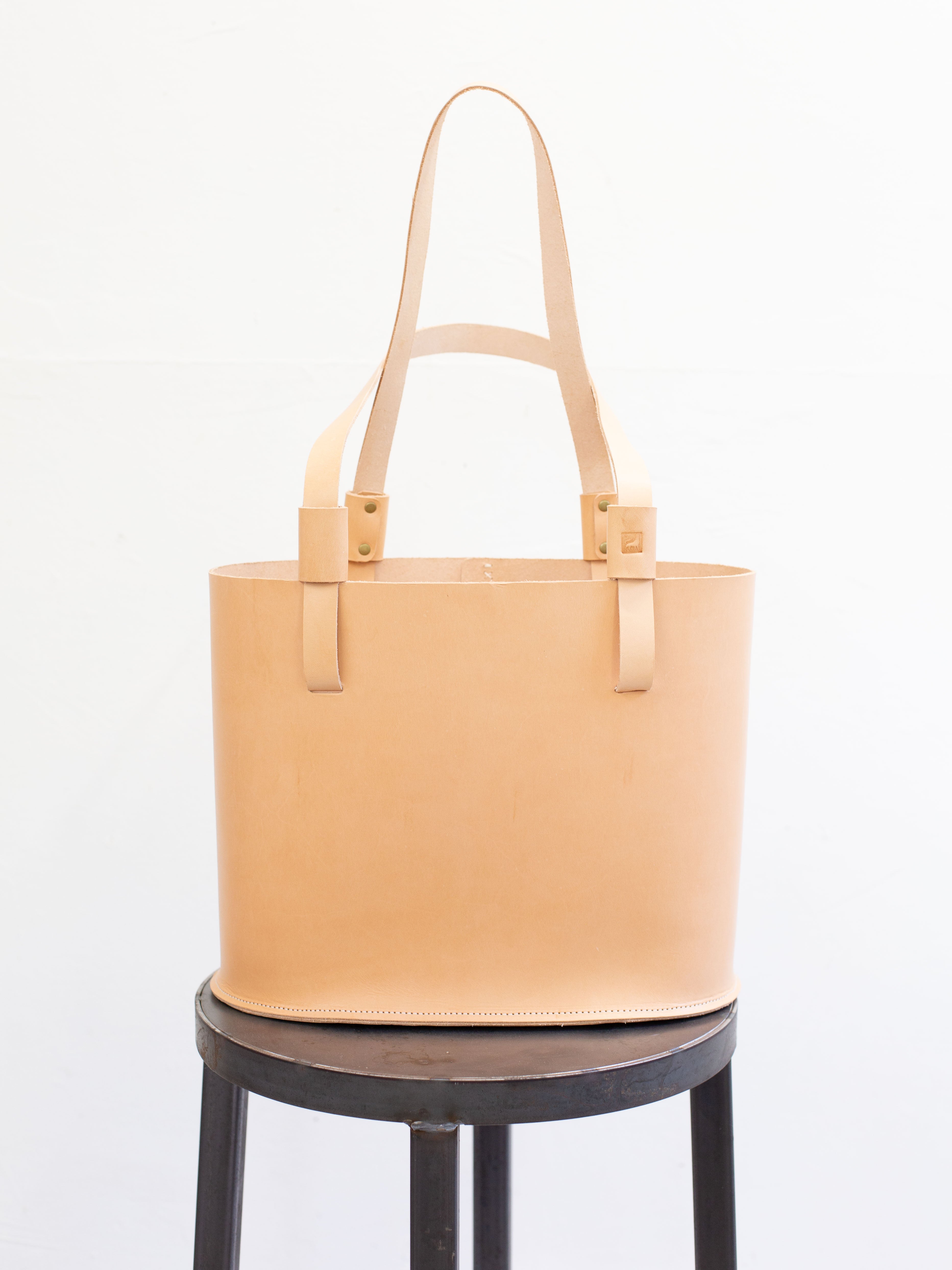 Medium sized leather tote bag, made from ethically sourced leather, in a undyed light tan color.  